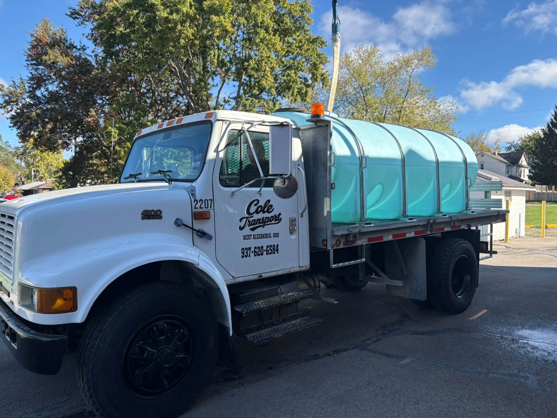 Cole Transport straight truck with a water tank, door lettered West Alexandria, Ohio